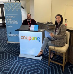 Coupang team members meeting U.S. small and medium-sized business owners at the ECRM retail show in Destin, Florida.